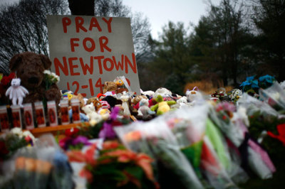 Flowers, candles and stuffed animals are seen at a makeshift memorial in Newtown, Connecticut December 17, 2012. Two funerals on Monday ushered in what will be a week of memorial services and burials for the 20 children and six adults massacred at Sandy Hook Elementary School in Newtown.