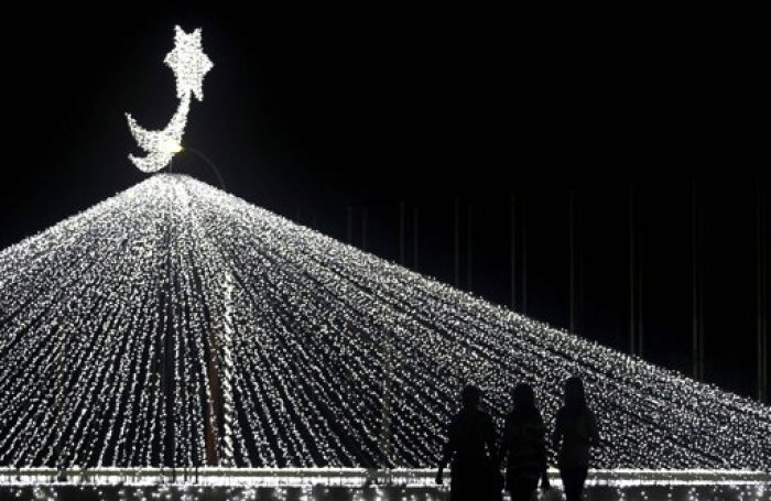 A group of women walk past Christmas decorations ahead of Christmas day celebrations in Colombo, December 23, 2012.