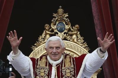 Pope Benedict XVI (C) waves as he blessed the crowd as he makes his ''Urbi et Orbi'' (To the city and the world) address from a balcony in St. Peter's Square in Vatican December 25, 2012.