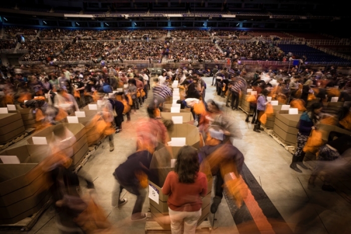After completing notes of encouragement, students attending Urbana 12 in St. Louis came down to the arena floor to assemble 32,000 AIDS caregiver kits in about two hours to be sent to Swaziland and other African countries, Dec. 29, 2012.