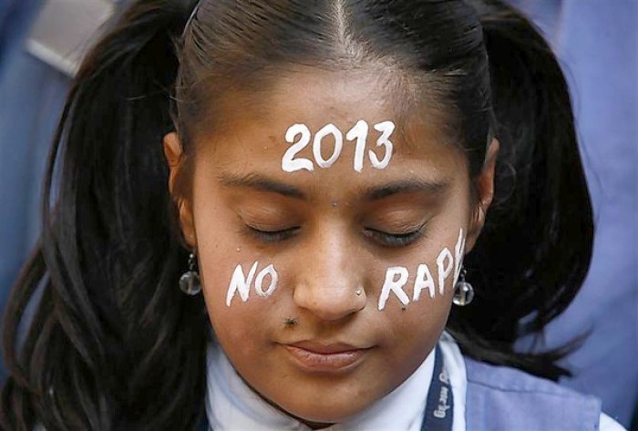 A student prays during a vigil for a gang rape victim, who was assaulted in New Delhi, in Ahmedabad, India, on Dec. 31, 2012
