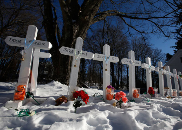 Crosses are seen at a memorial along the side of the road on the day the Sandy Hook School children will begin to attend classes in Monroe, Connecticut, January 3, 2013. Hundreds of children who had escaped a harrowing attack on their elementary school in Newtown, Connecticut, last month, headed back to classes Thursday for the first time since a gunman had barged into their school and killed 20 of their schoolmates and six staff members.