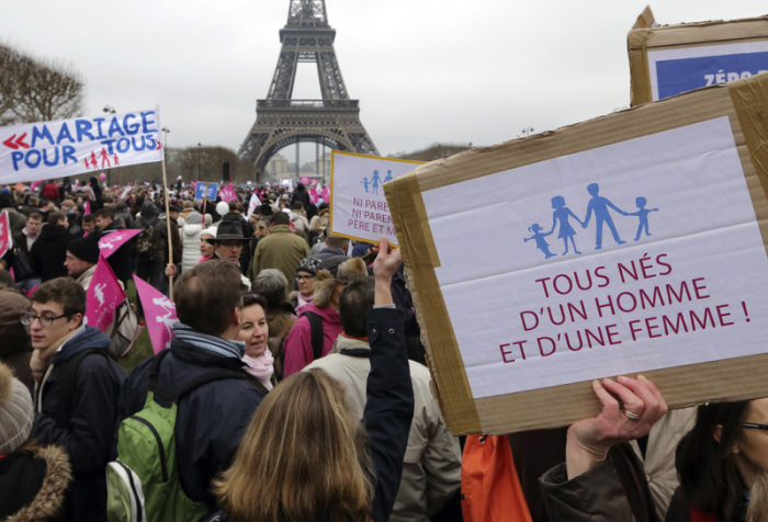Demonstrators takes part in a march in Paris, to protest France's planned legalisation of same sex marriage, January 13, 2013. The sign reads 'Everyone is born to a man and a woman'.