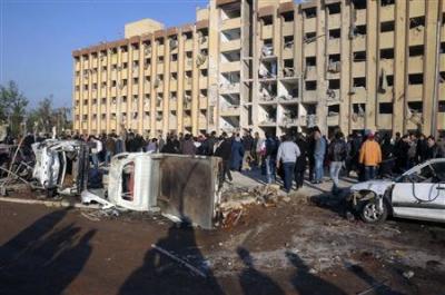 Syrian security personnel and civilians gather at the site where two explosions rocked the University of Aleppo in Syria's second largest city, January 15, 2013.