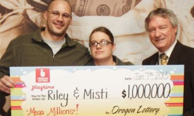 Riley Gunn and his wife pose with their winnings. They donated 10 percent of their winnings to their church as tithe.
