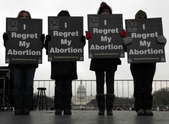 Activists hold signs reading 'I regret my abortion' onstage as they participate in the annual March for Life rally in Washington, January 25, 2013. The anti-abortion marchers on Friday marked the 40th anniversary of the Roe v. Wade U.S. Supreme Court ruling legalizing abortion, and Pope Benedict expressed support for the demonstrators.