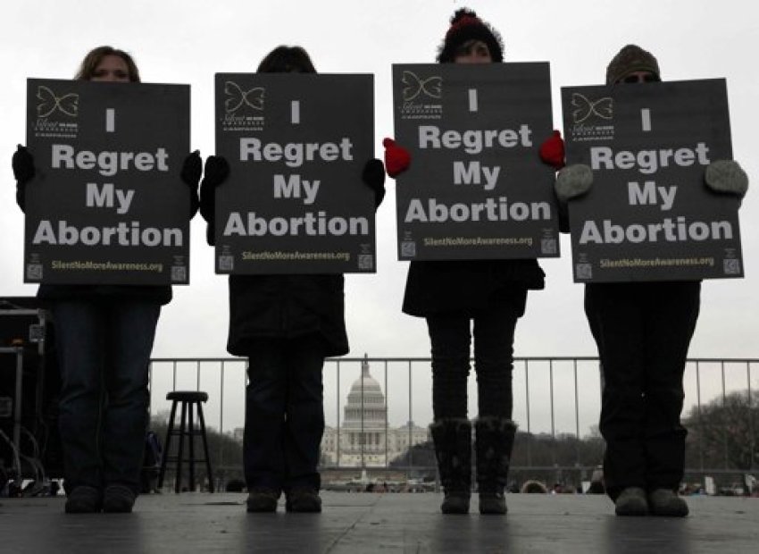 Activists hold signs reading "I regret my abortion" onstage as they participate in the annual March for Life rally in Washington, January 25, 2013. The anti-abortion marchers on Friday marked the 40th anniversary of the Roe v. Wade U.S. Supreme Court ruling legalizing abortion, and Pope Benedict expressed support for the demonstrators.