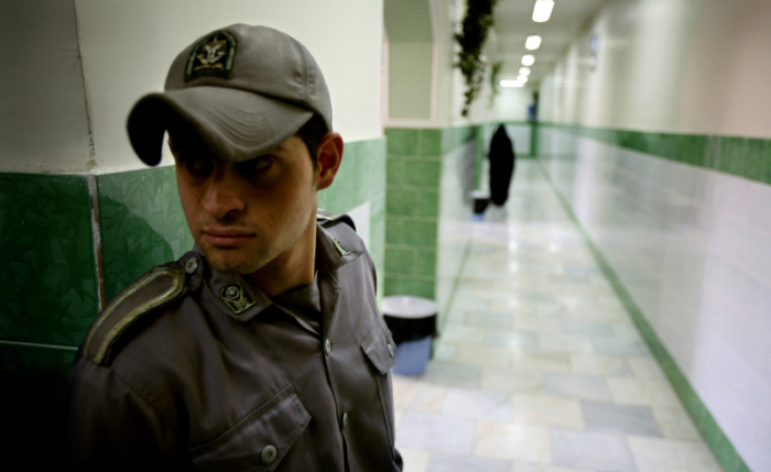 A prison guard stands along a corridor in Tehran's Evin prison in this June 13, 2006 file photo.