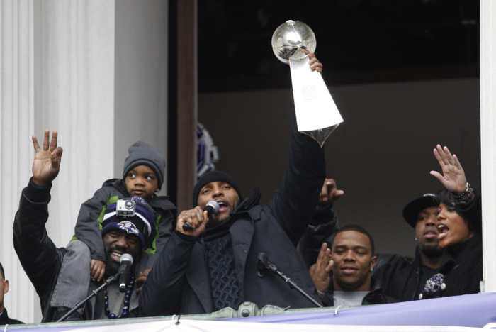 Baltimore Ravens retiring linebacker Ray Lewis (C) holds up the Vince Lombardi trophy as he stands with safety Ed Reed (L) during a rally at City Hall in Baltimore, Maryland February 5, 2013. The Ravens defeated the San Francisco 49ers to win the NFL championship.