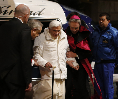 Pope Benedict XVI is helped as he arrives to attend a meeting with seminarians at the Romano Maggiore seminary in Rome in this February 8, 2013 file photo. Pope Benedict will step down as head of the Catholic Church on Feb. 28, the Vatican confirmed on February 11, 2013.