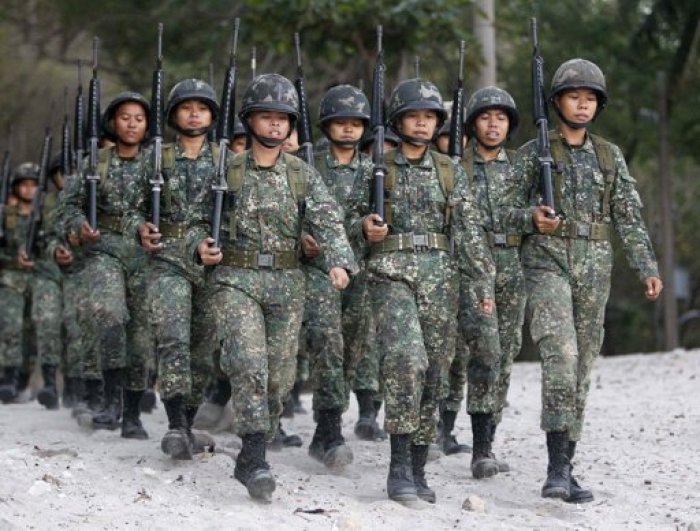 Newly recruited female marines march with fellow soldiers during drills inside the marine headquarters in the town of Ternate, Cavite city, south of Manila February 5, 2013.