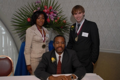 Benjamin Carson (seated) poses with recipients of scholarships from the Carson Scholars Fund.