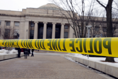 Police tape blocks a sidewalk at the Massachusetts Institute of Technology (MIT) in Cambridge, Massachusetts, February 23, 2013. Police searched a building at the MIT on Saturday before concluding that a report that a gunman was on campus wearing body armor was 'unfounded.'