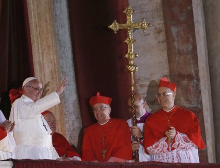Newly elected Pope Francis (L), the former Cardinal Jorge Bergoglio of Argentina appears on the balcony of St. Peter's Basilica after being elected by the conclave of cardinals, at the Vatican, March 13, 2013. Francis delivered his first blessing to a huge crowd in St Peter's Square on Wednesday night, asking for the prayers of 