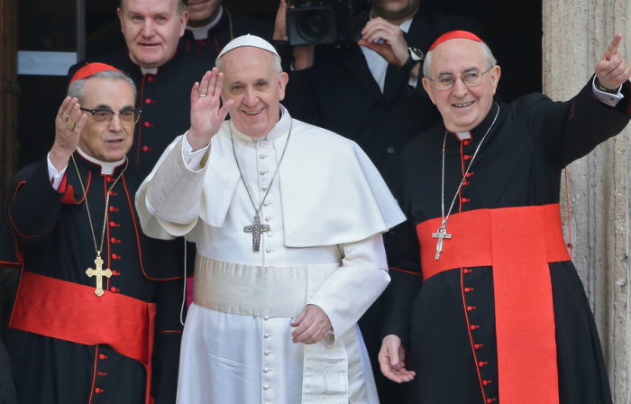 Newly elected Pope Francis, Cardinal Jorge Mario Bergoglio of Argentina waves from the steps of the Santa Maria Maggiore Basilica in Rome, March 14, 2013. At left is Cardinal Santos Abril of Spain and Cardinal Agostino Vallini, Vicar General of Rome at right.