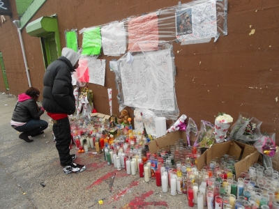 Residents of East Flatbush in Brooklyn, N.Y. pay their respects at a makeshift memorial set up in honor of 16-year-old Kimani Gray who was shot dead by NYPD officers in the community last Saturday.