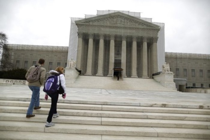 Tourists walk in front of the Supreme Court building in Washington, March 24, 2013. In their first-ever review of same-sex marriage laws, the nine justices on the country's highest court are hearing arguments on Tuesday and Wednesday on one of the most politically charged dilemmas of the day, bound with themes of religion, sexuality and social custom.