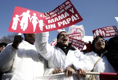 Supporters traditional marriage demonstrate in front of the Supreme Court in Washington March 26, 2013. U.S. Supreme Court justices signaled on Tuesday that they are reluctant to embrace a broad ruling finding a fundamental right to marriage for gays and lesbians across the United States. The sign reads, "It is better for children to have a mother and a father".