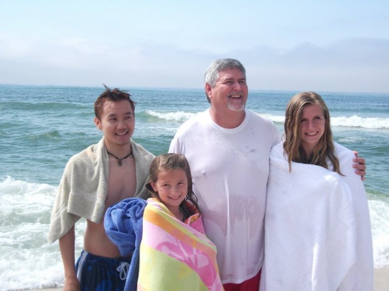 Pastor Mike Young poses with congregants at Chapel at the Beach after an Easter service baptism