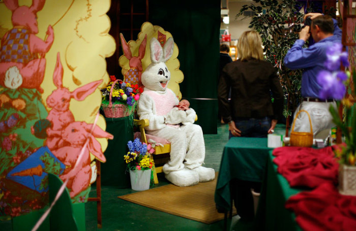 A person dressed as the Easter Bunny holds a baby while getting a picture taken at the Broadway Market in Buffalo, New York April 10, 2011.