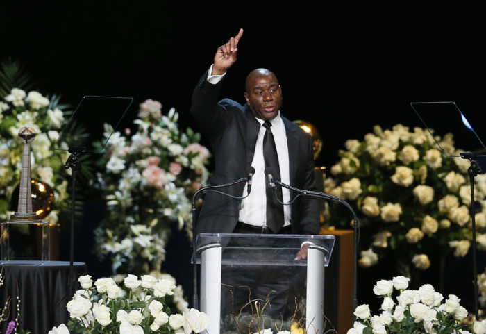 Former Lakers player Magic Johnson speaks at a memorial service for the late Los Angeles Lakers owner Jerry Buss in Los Angeles, February 21, 2013.
