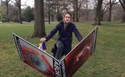 A female student destroys an anti-abortion display at Ohio State University on April 2, 2013.