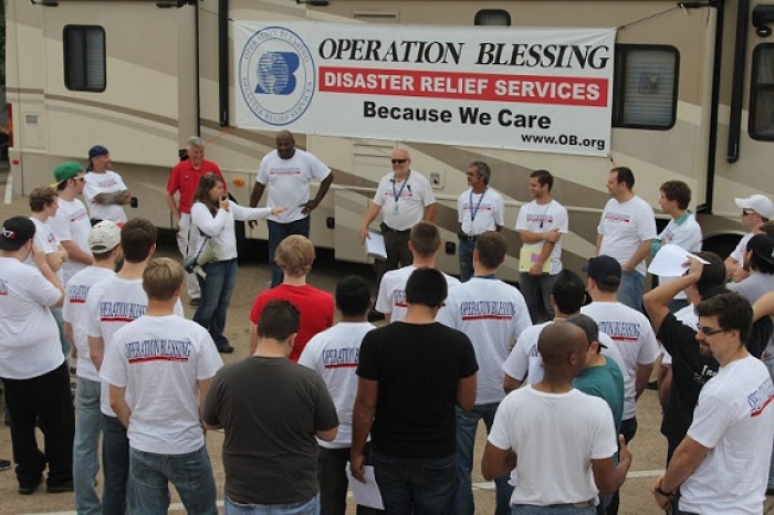 A team of Operation Blessing International aid workers gathering to help relief after a tornado.