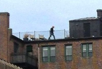 Picture captured man walking on roof near explosions
