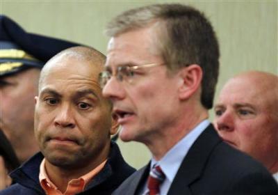 Massachusetts Governor Deval Patrick (L) listens as FBI Special Agent in Charge in Boston Richard DesLauriers briefs reporters during a news conference held to discuss the explosions at the Boston Marathon in Boston, Massachusetts April 15, 2013.