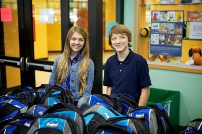 Olivia Osteen, niece of Pastor Joel Osteen, and Disney Channel's Jake Short fill backpacks on behalf of the 'Blessings in a Backpack' nonprofit organization, which seeks to end hunger among elementary school children in the U.S.