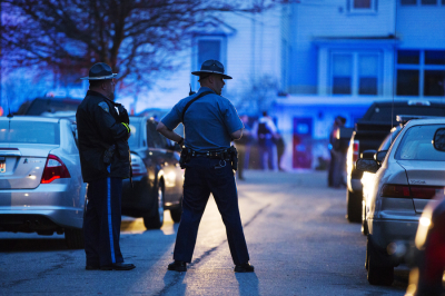 Law enforcement officials stand at the scene on Franklin St. as the search for Dzhokhar Tsarnaev, the surviving suspect in the Boston Marathon bombings, comes to an end in Watertown, Massachusetts April 19, 2013. The manhunt for Dzhokhar Tsarnaev, 19, one of two brothers believed to have carried out Monday's attack, took a dramatic turn just minutes after authorities announced they were lifting a shelter-in-place order imposed on the entire city of Boston.
