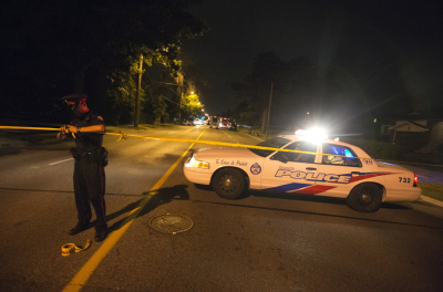 A Toronto police officer tapes up a crime scene in this file photo.