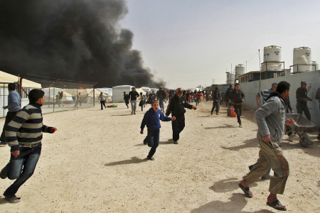 Syrians run from an explosion at the Al Zaatari Syrian refugee camp in the Jordanian city of Mafraq, near the border with Syria March 8, 2013.