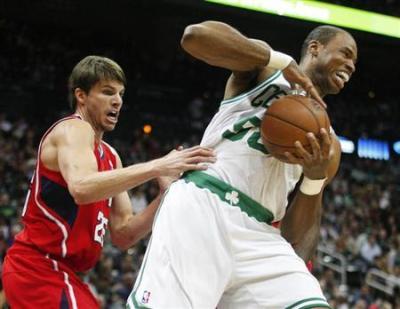 Former Boston Celtics center Jason Collins (R), grabs a rebound away from Atlanta Hawks guard Kyle Korver in the first half of their NBA basketball game in Atlanta, Georgia January 5, 2013.