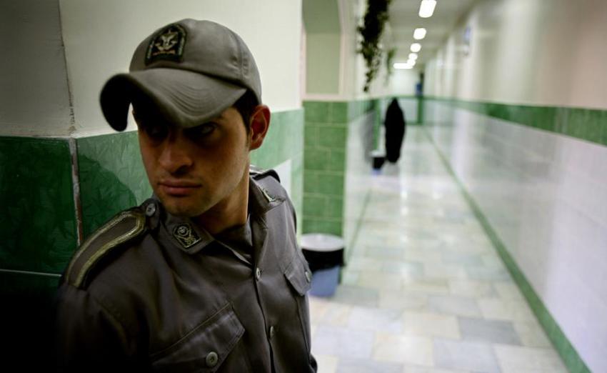 A prison guard stands along a corridor in Tehran's Evin prison June 13, 2006.