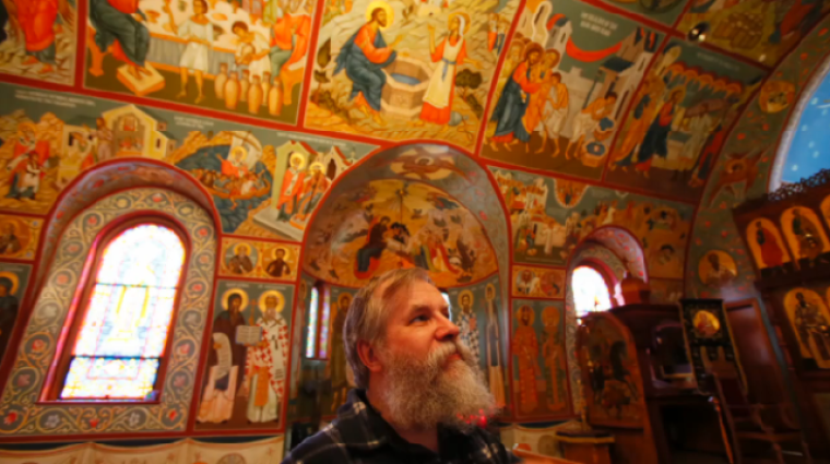 Iconographer Fr. Theodore Jurewicz looks up at the icons he painted over the last six years that cover the interior of St. Stephen Serbian Orthodox Church in Lackawanna, N.Y., on Monday, April 1, 2013.