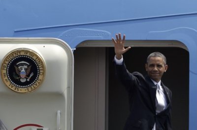 U.S. President Barack Obama waves from the steps of Air Force One upon his departure from the presidential hangar at Benito Juarez International Airport in Mexico City May 3, 2013.