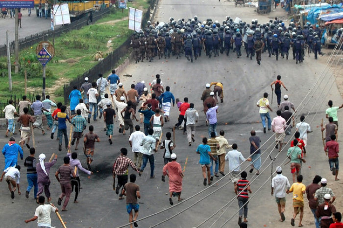 Conservative Islamist protesters chased police during a clash on May 6, 2013 in Narayanganj, Bangladesh.