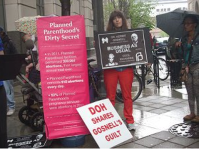 Protesters stand outside the Criminal Justice Center, at Juniper and Filbert Streets in center city Philadelphia, Pa., April 29, 2013.