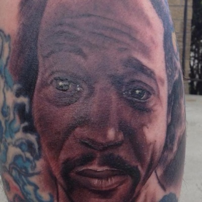 A tattoo of Cleveland hero, Charles Ramsey's face on Stephen Munhollon's leg.