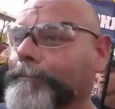 Ruben Israel, who oversees the website for Official Street Preachers, at a protest at the Arab International Festival held in Dearborn, Michigan in 2012. Still taken from YouTube video documenting the violent response to a group of Christian evangelists demonstrating at the Festival.