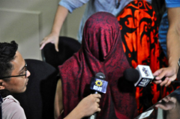 A raid lead to the rescue of 30 Filipino girls who were reportedly on the way to be trafficked to Syria. The Visayan Forum and the Philippines Police Department of Justice conducted the raid. This photo was taken at the police station where the girls, hiding their faces behind veils, were brought for investigation after the rescue.