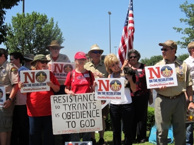 Parents, grandparents and Boy Scouts troop leaders pose for pictures during their public protest against the BSA's proposed resolution to allow openly-gay membership into the scouts. A total of 1,400 delegates will be voting on the resolution on May 23 at the national annual meeting, held this year at the Gaylord Texan in Grapevine, Texas. May 22, 2013.