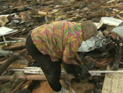 Moore, Okla., resident Barbara Garcia was overwhelmed with emotion when her pet dog Bazzie was discovered just behind her in the rubble of her house that hat been struck by a tornado. Garcia was interviewing with CBS News on Monday, May 21, 2013, when a camera crew spotted the mini schnauzer.