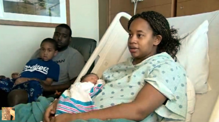 Oklahoma mom Shayla Taylor tells how she survived a powerful tornado while in labor on Monday, May 20, 2013, at the Moore Medical Center. Her husband and 4-year-old son look on as Taylor holds her newborn son, Braeden Immanuel Taylor.