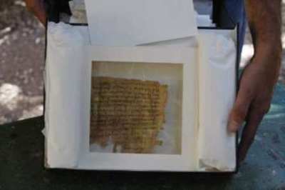 Amir Ganor, director of the unit for the prevention of antiquities robbery in the Israeli Antiquities Authority, shows a document, thought to be an ancient text written on papyrus, at Jerusalem Magistrates Court May 6, 2009. According to the Israeli Antiquities Authority, the document is written in ancient Hebrew script, which is characteristic of the Second Temple period and the first and second centuries CE. This style of writing is primarily known from the Dead Sea scrolls and various inscriptions that occur on ossuaries and coffins. It was seized from two men suspected to be antiquities robbers in an elaborate undercover operation