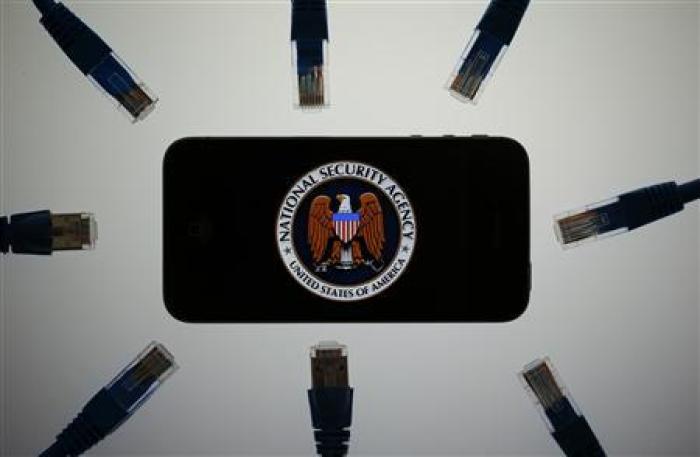 An illustration picture shows the logo of the U.S. National Security Agency on the display of an iPhone in Berlin, June 7, 2013. The debate over whether the U.S. government is violating citizens' privacy rights while trying to protect them from terrorism escalated dramatically on Thursday amid reports that authorities have collected data on millions of phone users and tapped into servers at nine internet companies.