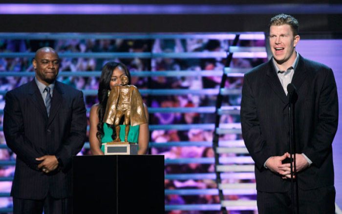 Baltimore Ravens' Matt Birk (R) accepts the Walter Payton Man of the Year award as Jarrett Payton and Brittney Payton look on at the Inaugural National Football League Honors at Super Bowl XLVI in Indianapolis, Indiana, February 4, 2012.