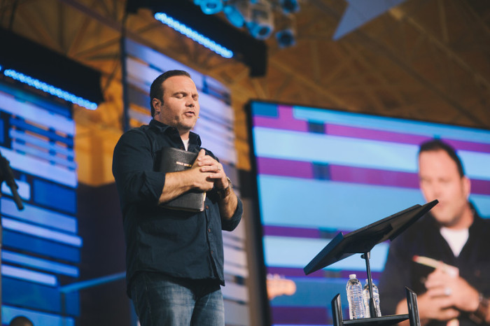 Pastor Mark Driscoll of Seattle-based Mars Hill Church leads congregation at Saddleback Church in Lake Forest, Calif., in prayer during his appearance as guest pastor for a weekend sermon while Pastor Rick Warren is on sabbatical, June 8, 2013.
