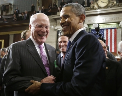 U.S. President Barack Obama (R) is greeted by Senator Patrick Leahy (D-VT) as he leaves after giving his State of the Union speech on Capitol Hill in Washington, February 12, 2013.
